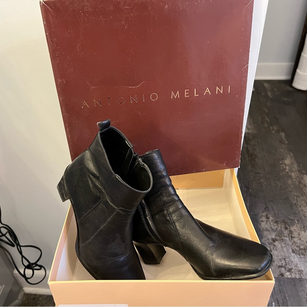 Black leather boots. Good condition. A scuff on one of the heels.